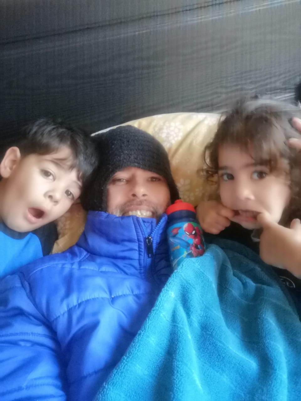 Kevin, Gabi and Zack Vermaak laying on the Bed pulling funny faces